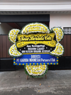 Papan Bunga Duka di Figur